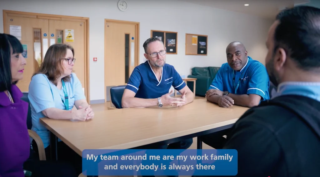 nhs staffs talking at a table